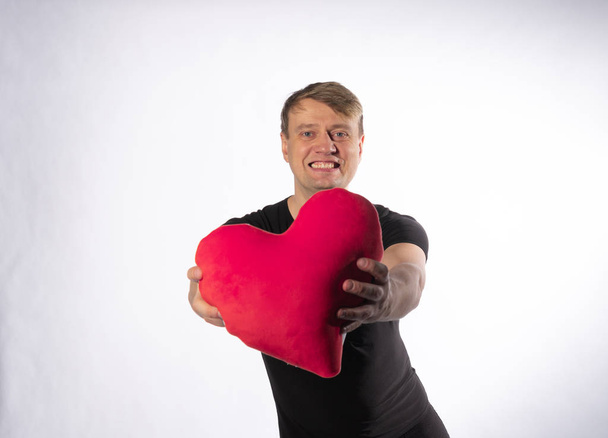 The guy is in the hands of heart for the happiness of Valentines day on white background - Photo, image