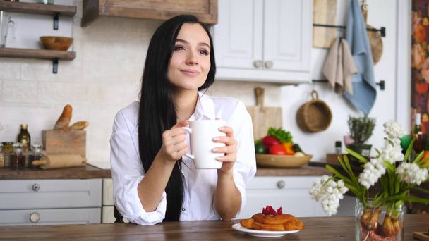 Young Girl With Cup Of Coffee Or Tea Relaxing On Kitchen At Home. - Photo, image