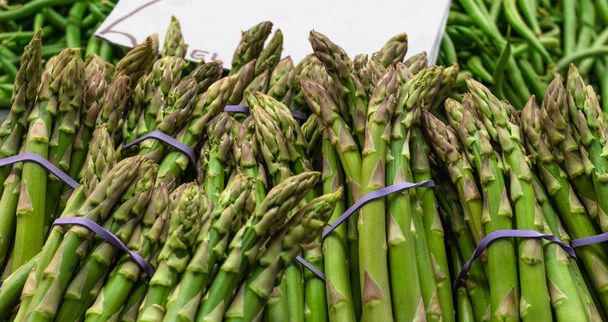 raw asparagus sticks on the market. fresh and green with a lot of vitamins - Photo, image