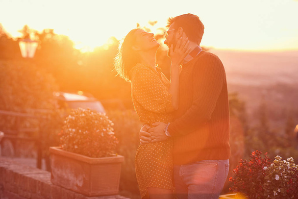 man and woman hugging and kissing at the sunset  - Foto, Bild