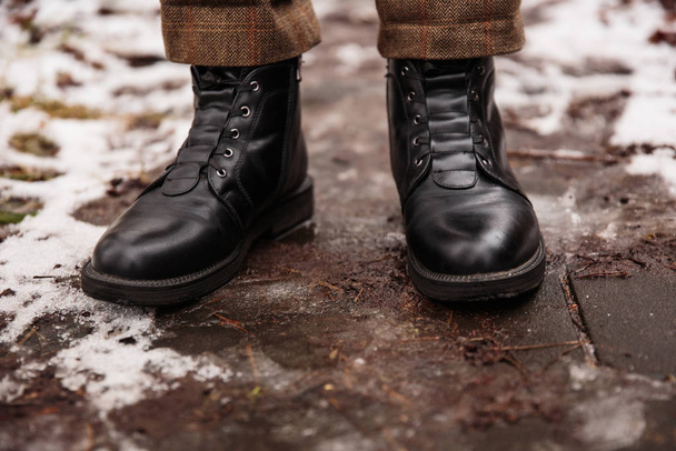 Female feet in black boots, winter walking in snow - Photo, Image