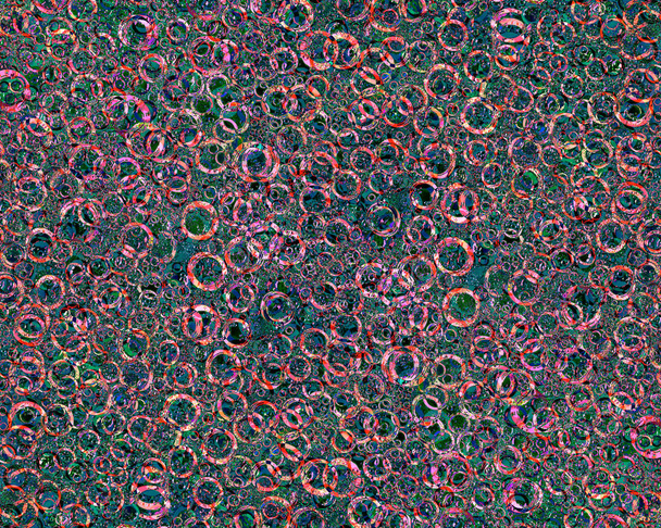 Patrón de anillos entrelazados aleatoriamente de diferentes diámetros y colores sobre un fondo variopinto. Abstracción del caos
. - Foto, Imagen