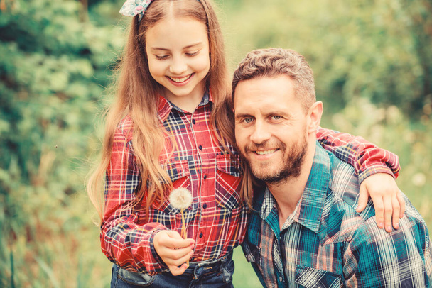 daughter and father with dandelion. little girl and happy man dad. earth day. spring village country. ecology. Happy family day. family summer farm. Help and support - Fotoğraf, Görsel