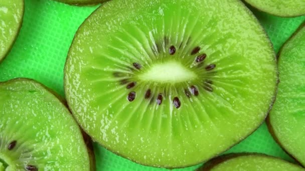 slice of juicy fresh kiwi rotates on the table in close-up - Footage, Video