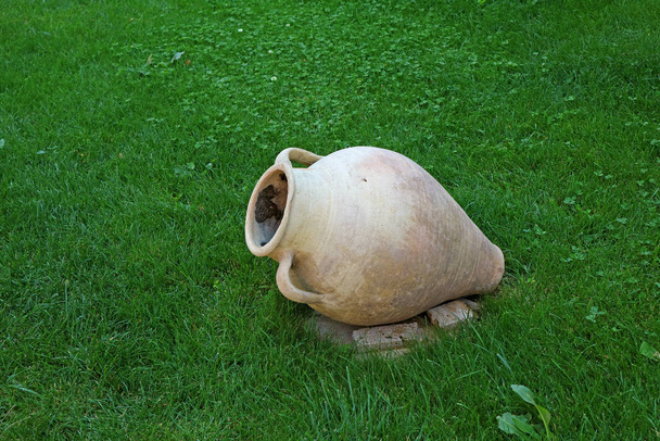 Ancient Style Armenian Wine Jar Isolated on Vibrant Green Lawn - Photo, Image