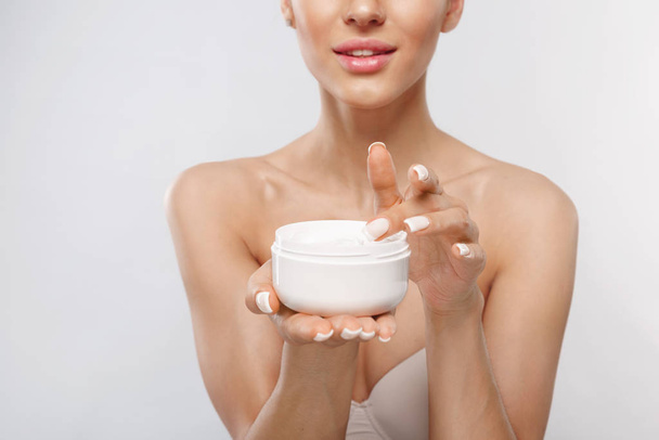 Skin Care Product. Closeup Of Woman Hands Holding Face Cream In A Jar. Beautiful Female Hands With Natural Manicure And Healthy Nails Holding Body Lotion. Beauty Concept - Zdjęcie, obraz