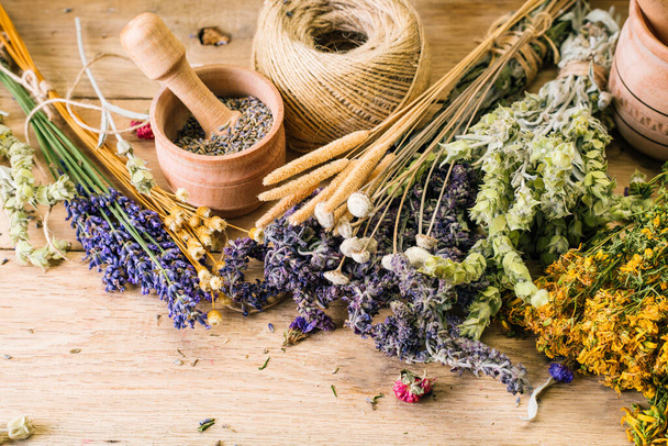 Harvesting medicinal herbs, alternative medicine, Ayurveda, dried flowers - Photo, Image
