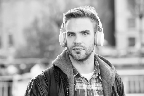 While walk. Online education courses. Listen music. Ebook audio concept. Student study use headphones. Handsome man urban background defocused. Distance education. Remote studying. Modern education - Foto, afbeelding