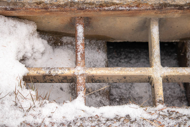 Rusting Grating of Storm Drain on Snowy Roadside - Photo, Image