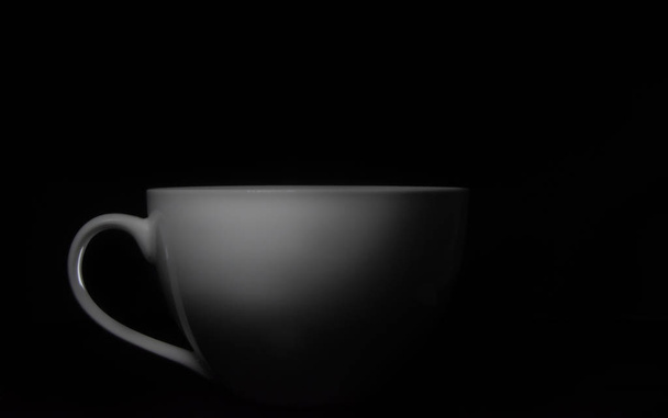 White porcelain cup on black background - Foto, Imagem