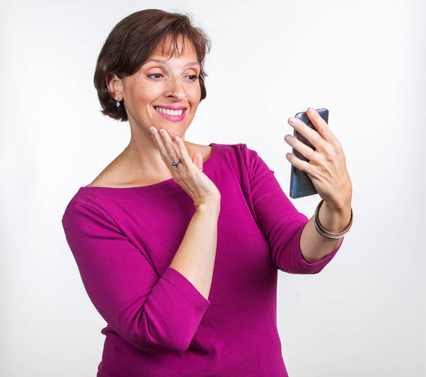 Middle Aged woman taking a selfie - Zdjęcie, obraz