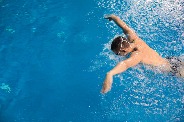 Male swimmer at the swimming pool. Underwater photo. Male swimmer. - Zdjęcie, obraz