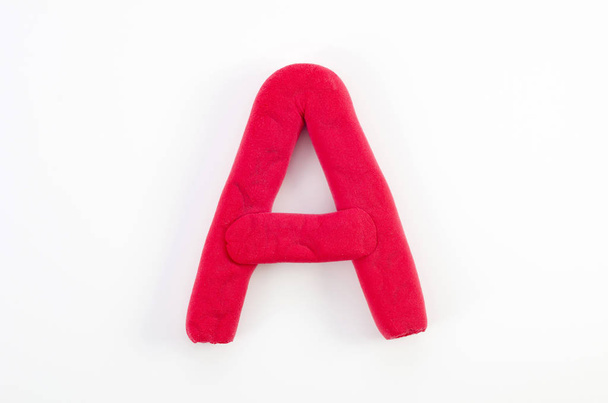 Red plasticine letter A uppercase of English alphabet isolated on white background - Photo, Image