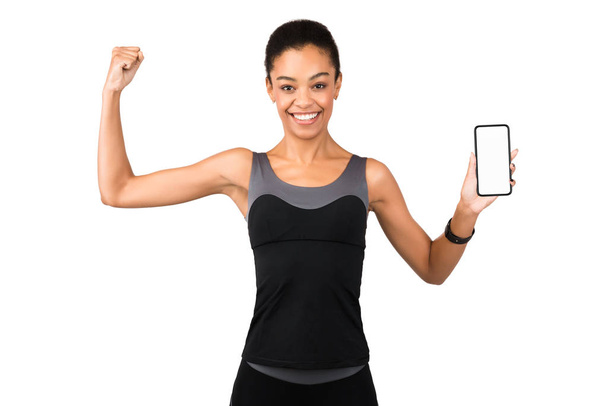 Girl Showing Phone Blank Screen And Biceps Posing, White Background - Photo, Image