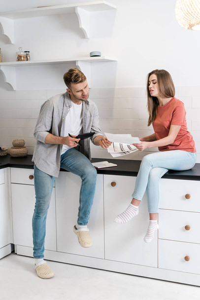 Young adult woman and man spending morning in kitchen - Fotoğraf, Görsel