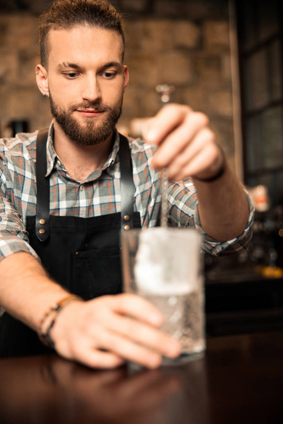 Bartender is preparing a refreshing cocktail with ice - Photo, Image