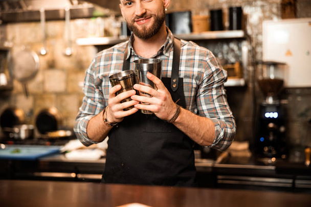 Young man working as bartender in bar - Foto, Bild
