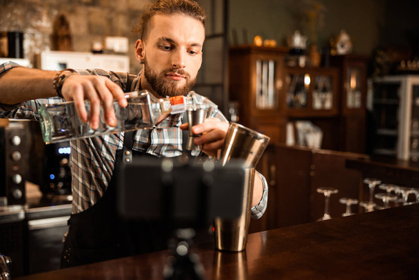 Young bartender filming vlog about his work - Fotoğraf, Görsel