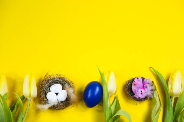 Tulips, Easter egg, Easter basket on yellow background - Foto, afbeelding