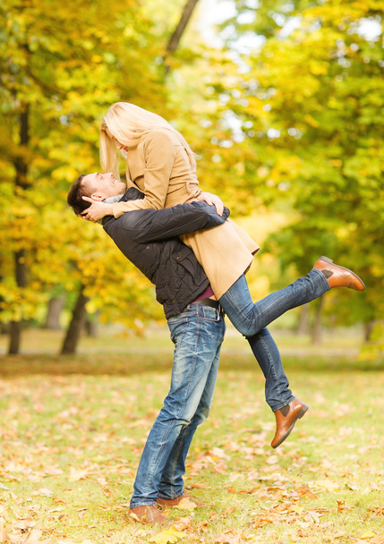 Romantic couple playing in the autumn park - Fotoğraf, Görsel