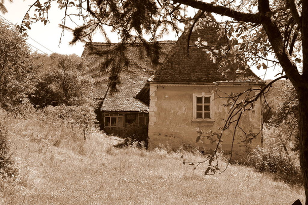 Typical rural landscape and peasant houses in  the village Alma Vii (Almen) Transylvania, Romania. The settlement was founded by the Saxon colonists in the middle of the 12th century - Photo, Image