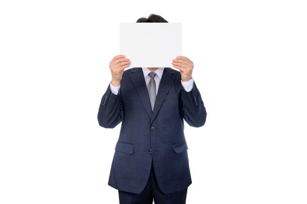 Portrait of Asian businessman holding blank message board. - Foto, afbeelding