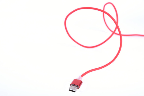 Red USB cable for smartphone charge isolated on white background. - Photo, Image