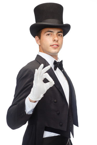 Magician in top hat showing trick - Foto, Imagen