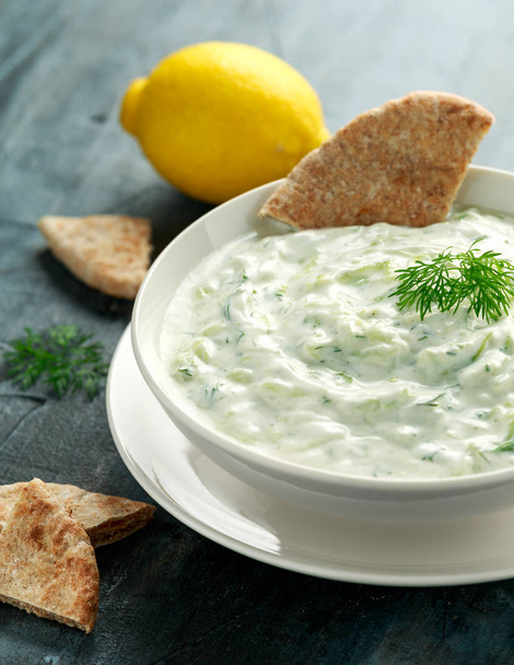Tzatziki dip sauce with greek yogurt, garlic, dill and cucumber in white bowl - Φωτογραφία, εικόνα