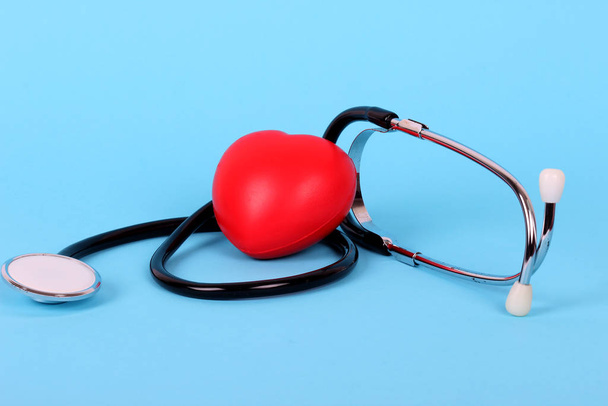 stethoscope and heart isolated on blue background - Fotó, kép