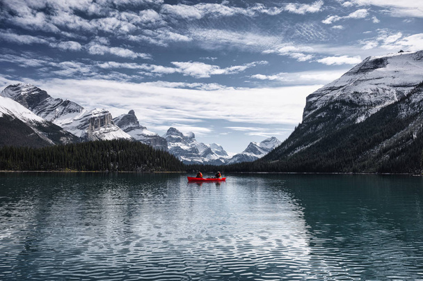 Traveler canoeing on Maligne lake with Canadian rockies in Spiri - Photo, Image