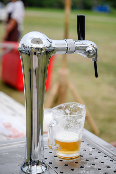 Draft beer in mug on handle tap machine - Photo, Image