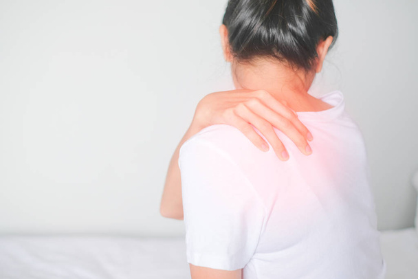 Woman suffering from back pain on white background, Healthcare concept - Photo, Image