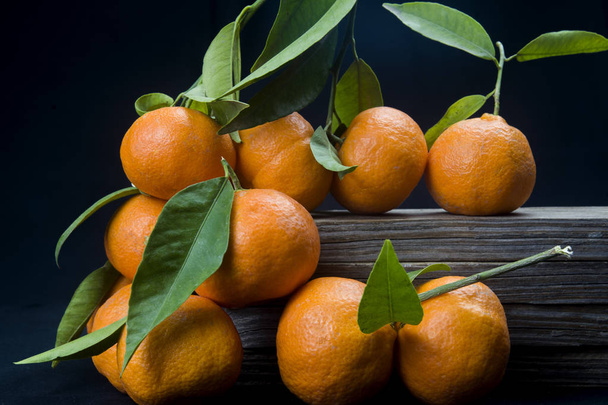 organic tangerines with leaves on black background - Photo, Image