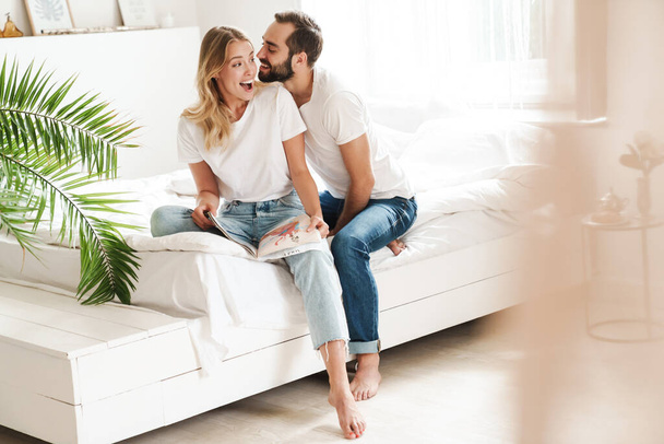 Happy young couple in love relaxing on a couch at the living room - Foto, Imagen