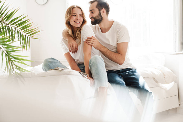 Happy young couple in love relaxing on a couch - Фото, изображение