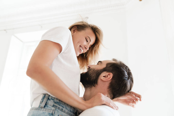 Beautiful happy young couple in love embracing at home - Photo, Image