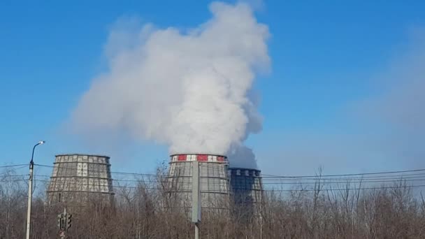 Industrial zone with large pipes cooling towers, with puffs of white dense smoke, the work of a thermal power station in a big city. Ecological problems, climate warming, environmental pollution. - Footage, Video