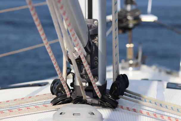 The base for securing the mainsail on the deck of a cruise yacht. Folding carriages and ropes for raising sails. Bermuda sloop equipment. The device and management of a sailing yacht. Visual aids - Photo, Image