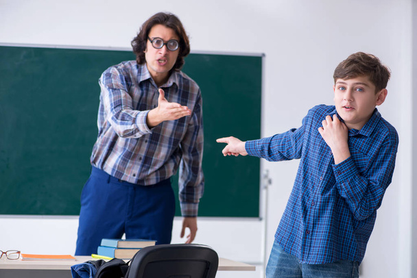 Funny male teacher and boy in the classroom - Photo, Image
