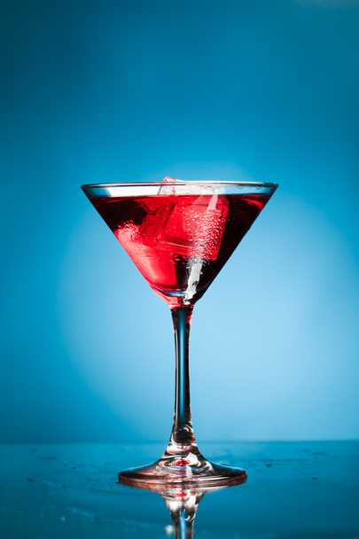 red martini cocktail, blue background - Fotoğraf, Görsel