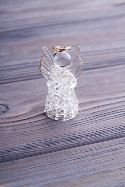 Glass crystal angel on wood. - Photo, Image
