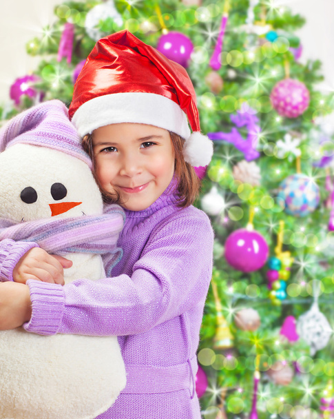 Happy girl with snowman toy - Фото, изображение