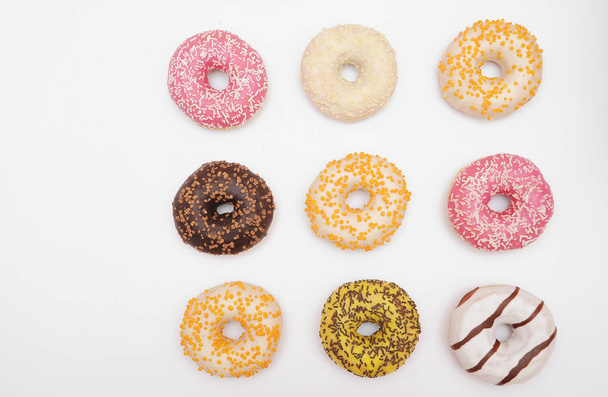 Delicious donuts on light background. - Fotoğraf, Görsel