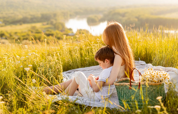 Sister and brother sitting together on green meadow - Foto, Imagem