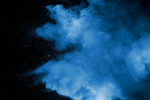 Abstract art blue powder on black background. - Photo, Image