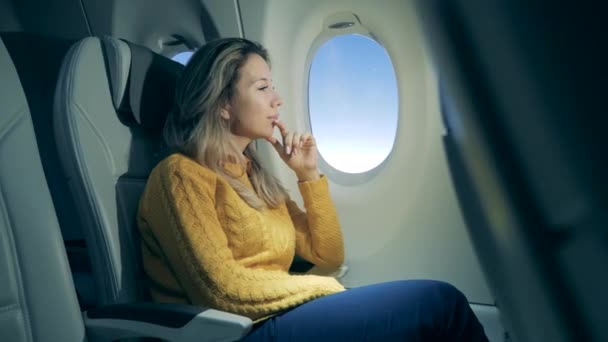 Aircraft cabin with a gorgeous woman in it while flying - Video