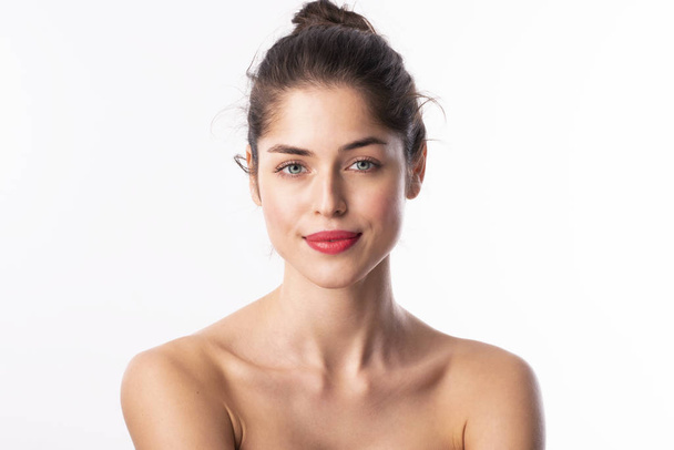 Portrait of gorgeous young woman with perfect skin wearing red lipstick while posing at isolated white background with copy space.  - Φωτογραφία, εικόνα