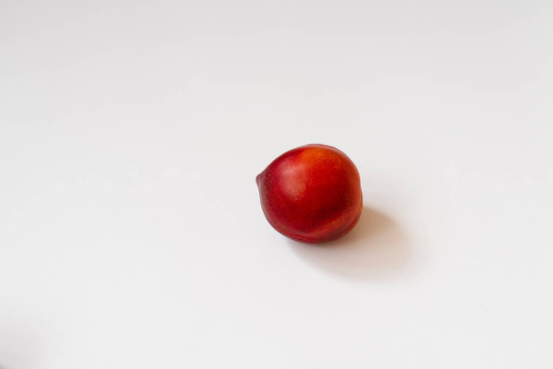 Fresh organic nectarine lies on a white background with a copy o - Foto, immagini