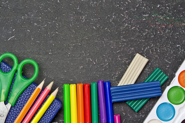 School and office supplies on a blackboard. Stationery. - Photo, Image